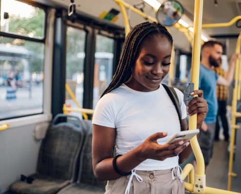 Experiential marketing promotional marketing with a lady on a bus on her phone engaging